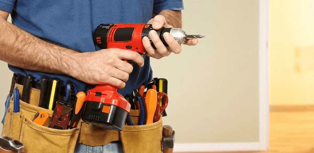 Handyman holding a power drill for home repairs and installations in Cape Coral, FL